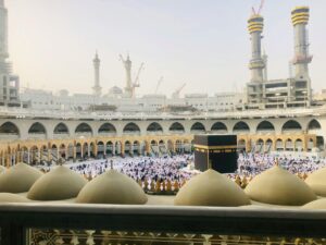 View of Kaaba with pilgrims at Masjid al-Haram in Mecca, Saudi Arabia during day.